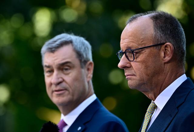 (L-R) Bavaria's State Premier and leader of the conservative Christian Social Union (CSU) Markus Soeder and German Chancellor Friedrich Merz (CDU)  address a press conference, on July 2, 2026 in the garden of the Chancellery in Berlin, one day after their coalition committee consultations on a major package of reforms. (Photo by Tobias SCHWARZ / AFP)