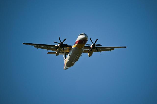 A Dash Fireguard aircraft of the civil security flies during a wildfire in Pouzols-Minervois, southern France on July 2, 2026. One year after the wildfire in the Corbières massif, the south of France has once again been hit by a large-scale blaze that broke out on July 1, 2026 afternoon in the Herault before quickly spreading to the neighboring department of Aude under the combined effect of drought and wind, and is being fought by hundreds of firefighters. (Photo by Lionel BONAVENTURE / AFP)