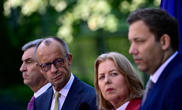 (L-R) Bavaria's State Premier and leader of the conservative Christian Social Union (CSU) Markus Soeder, German Chancellor Friedrich Merz (CDU),  German Minister for Labour and Social Affairs Baerbel Bas (SPD) and German Finance Minister and Vice Chancellor Lars Klingbeil (SPD) address a press conference, on July 2, 2026 in the garden of the Chancellery in Berlin, one day after their coalition committee consultations on a major package of reforms. (Photo by Tobias SCHWARZ / AFP)