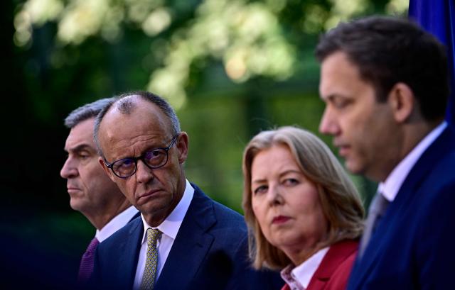 (L-R) Bavaria's State Premier and leader of the conservative Christian Social Union (CSU) Markus Soeder, German Chancellor Friedrich Merz (CDU),  German Minister for Labour and Social Affairs Baerbel Bas (SPD) and German Finance Minister and Vice Chancellor Lars Klingbeil (SPD) address a press conference, on July 2, 2026 in the garden of the Chancellery in Berlin, one day after their coalition committee consultations on a major package of reforms. (Photo by Tobias SCHWARZ / AFP)