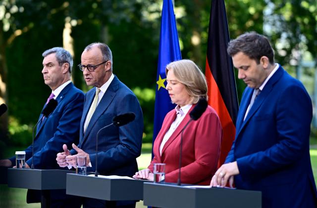 (L-R) Bavaria's State Premier and leader of the conservative Christian Social Union (CSU) Markus Soeder, German Chancellor Friedrich Merz (CDU), German Minister for Labour and Social Affairs Baerbel Bas (SPD) and German Finance Minister and Vice Chancellor Lars Klingbeil (SPD) address a press conference, on July 2, 2026 in the garden of the Chancellery in Berlin, one day after their coalition committee consultations on a major package of reforms. (Photo by Tobias SCHWARZ / AFP)