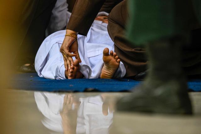 A woman who allegedly had sexual intercourse on a TikTok livestream reacts after being caned as punishment under sharia law in Banda Aceh on July 2, 2026. (Photo by CHAIDEER MAHYUDDIN / AFP)