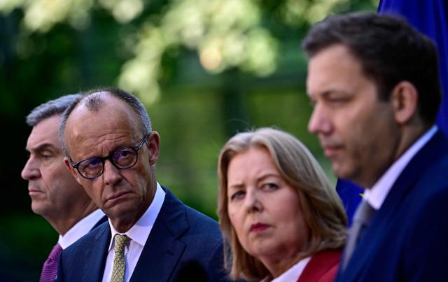 (L-R) Bavaria's State Premier and leader of the conservative Christian Social Union (CSU) Markus Soeder, German Chancellor Friedrich Merz (CDU),  German Minister for Labour and Social Affairs Baerbel Bas (SPD) and German Finance Minister and Vice Chancellor Lars Klingbeil (SPD) address a press conference, on July 2, 2026 in the garden of the Chancellery in Berlin, one day after their coalition committee consultations on a major package of reforms. (Photo by Tobias SCHWARZ / AFP)