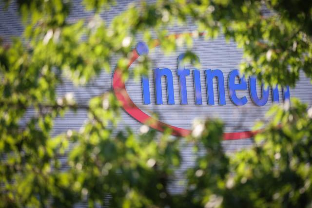 The logo of German semiconductor manufacturer Infineon Technologies AG is seen at the company's plant in Dresden, eastern Germany, on July 2, 2026, prior to the official inauguration of the company's "Smart Power Fab". With an investment of five billion euros, the new facility represents the largest single investment in Infineon's history. (Photo by Ronny HARTMANN / AFP)
