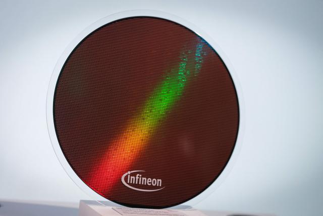 A 300mm wafer is pictured before the opening ceremony of the new Smart Power Fab of German semiconductor manufacturer Infineon Technologies AG in Dresden, eastern Germany, on July 2, 2026. With an investment of five billion euros, the new facility represents the largest single investment in Infineon's history. (Photo by Ronny HARTMANN / AFP)