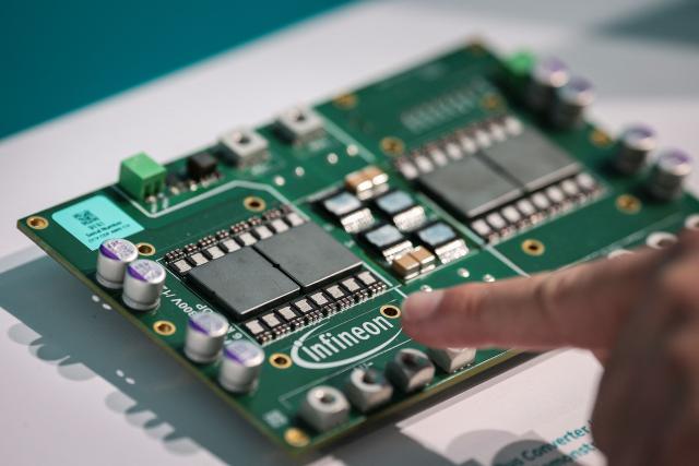 An Intermediate Bus Converter (IBC), designed for AI Server architectures, is pictured before the opening ceremony of the new Smart Power Fab of German semiconductor manufacturer Infineon Technologies AG in Dresden, eastern Germany, on July 2, 2026. With an investment of five billion euros, the new facility represents the largest single investment in Infineon's history. (Photo by Ronny HARTMANN / AFP)
