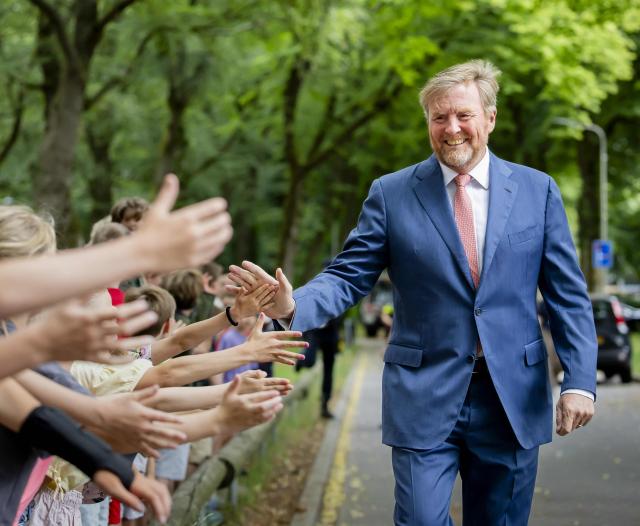 King Willem-Alexander of The Netherlands salute schoolchildren during a visit in Austerlitz, near Utrecht, focused on wildfires preventive measures taken at local, regional, and national levels, on July 2, 2026. (Photo by Sem van der Wal / ANP / AFP) / Netherlands OUT