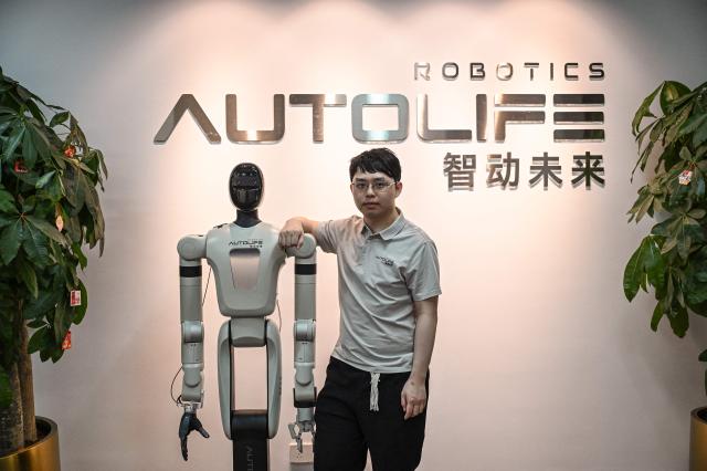 The photo taken on March 17, 2026 shows founder of Autolife Robotics Chen Siwei posing for a portrait at Autolife Robotics Engineering Office in Shenzhen, southern China's Guangdong province. (Photo by Jade GAO / AFP)