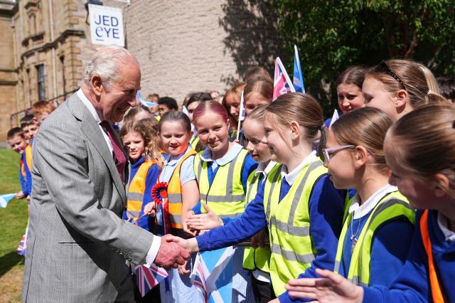 Britain's King Charles III (L) meets children during a visit to coincide with the Jethart Callant Festival in Jedburgh, Scotland on July 2, 2026. (Photo by Aaron Chown / POOL / AFP)