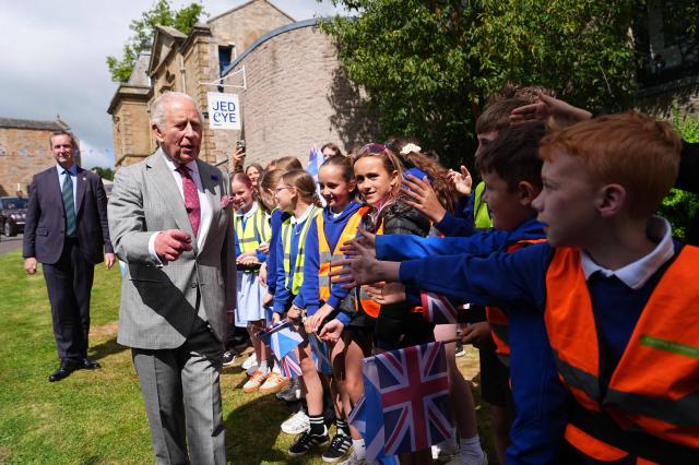 Britain's King Charles III (L) meets children during a visit to coincide with the Jethart Callant Festival in Jedburgh, Scotland on July 2, 2026. (Photo by Aaron Chown / POOL / AFP)