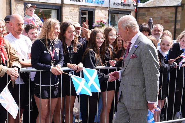 Britain's King Charles III (R) meets members of the public during a visit to coincide with the Jethart Callant Festival in Jedburgh, Scotland on July 2, 2026. (Photo by Aaron Chown / POOL / AFP)