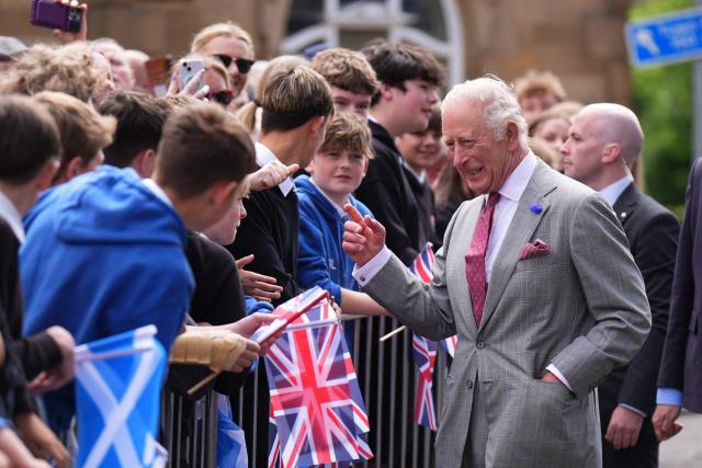 Britain's King Charles III (R) meets members of the public during a visit to coincide with the Jethart Callant Festival in Jedburgh, Scotland on July 2, 2026. (Photo by Aaron Chown / POOL / AFP)