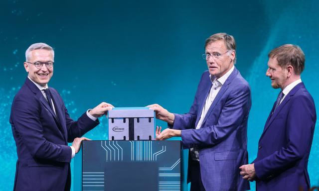 (2ndL-R) German Minister for Digitalization and State Modernization Karsten Wildberger, CEO of Infineon Jochen Hanebeck and Saxony's State Premier Michael Kretschmer unveil a 300mm wafer during the opening ceremony of the Infineon Smart Power Fab in Dresden, eastern Germany, on July 2, 2026. German semiconductor giant Infineon officially opens a large new chip factory in eastern Germany on July 2, three months ahead of schedule. The new, highly automated plant -- which cost 5 billion euros ($5.7 billion) -- has been repeatedly held up as a symbol of the European Union's push to bolster the domestic tech sector and reduce dependency for crucial parts on Asia and the United States. (Photo by Ronny HARTMANN / AFP)