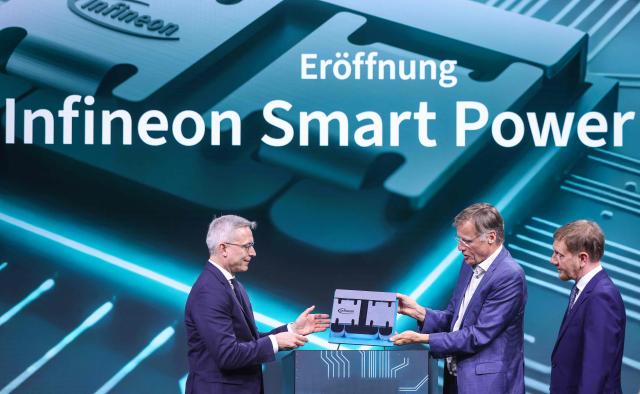 (2ndL-R) German Minister for Digitalization and State Modernization Karsten Wildberger, CEO of Infineon Jochen Hanebeck and Saxony's State Premier Michael Kretschmer unveil a 300mm wafer during the opening ceremony of the Infineon Smart Power Fab in Dresden, eastern Germany, on July 2, 2026. German semiconductor giant Infineon officially opens a large new chip factory in eastern Germany on July 2, three months ahead of schedule. The new, highly automated plant -- which cost 5 billion euros ($5.7 billion) -- has been repeatedly held up as a symbol of the European Union's push to bolster the domestic tech sector and reduce dependency for crucial parts on Asia and the United States. (Photo by Ronny HARTMANN / AFP)