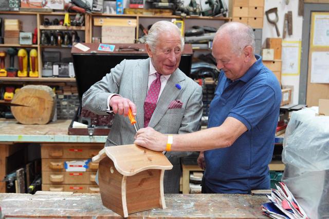 Britain's King Charles III (L) helps to assemble a roof on a birdhouse at Jed Shed during a visit to coincide with the Jethart Callant Festival in Jedburgh, Scotland on July 2, 2026. (Photo by Aaron Chown / POOL / AFP)