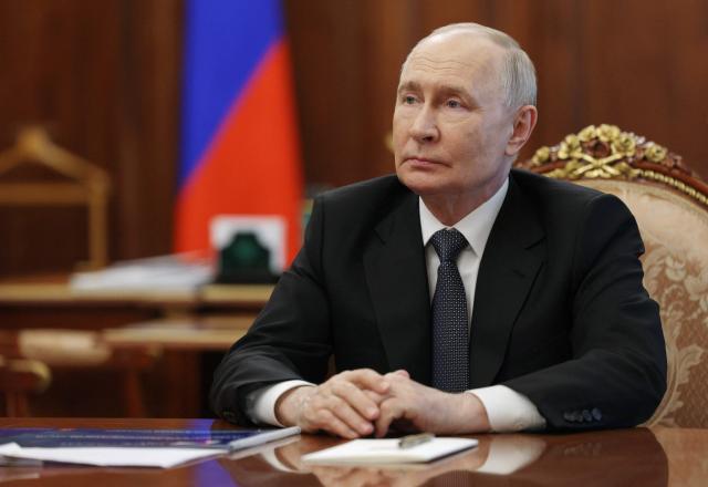 In this pool photograph distributed by the Russian state agency Sputnik, Russia's President Vladimir Putin attends a meeting with the Kaliningrad region governor in Moscow on July 2, 2026. (Photo by Gavriil Grigorov / POOL / AFP)