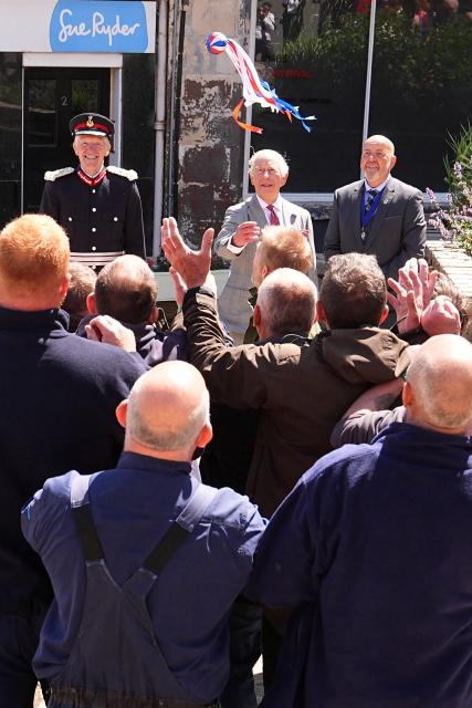 Britain's King Charles III (behind C) starts a traditional game of hand ba', during a visit to coincide with the Jethart Callant Festival in Jedburgh, Scotland on July 2, 2026. (Photo by Aaron Chown / POOL / AFP)