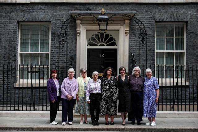 Campaigners pose for a photograph after a meeting with Britain's Prime Minister Keir Starmer to discuss historical forced adoption, outside 10 Downing Street in London on July 2, 2026. (Photo by Isabel Infantes / POOL / AFP)