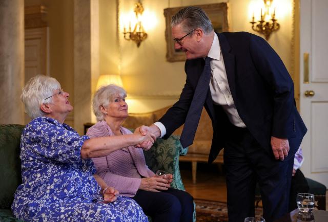 Britain's Prime Minister Keir Starmer (R) welcomes campaigners for a meeting to discuss historical forced adoption, at Downing Street in London on July 2, 2026. (Photo by Isabel Infantes / POOL / AFP)