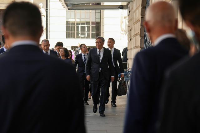China’s Commerce Minister Wang Wentao (C) arrives to attend the 15th UK–China Joint Economic and Trade Commission with his British counterparts at Mansion House in central London on July 2, 2026. (Photo by CARLOS JASSO / AFP)