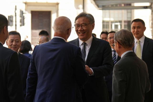 China’s Commerce Minister Wang Wentao (centre R) is welcomed as he arrives to attend the 15th UK–China Joint Economic and Trade Commission with his British counterparts at Mansion House in central London on July 2, 2026. (Photo by CARLOS JASSO / AFP)