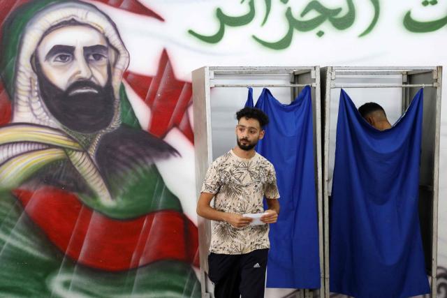 A man prepares to cast his ballot at a polling station during parliamentary elections in Algiers on July 2, 2026. Algerians headed to the polls on July 2 to elect a new parliament in an election shadowed by expectations of low turnout among the 25-million-person electorate. (Photo by AFP)