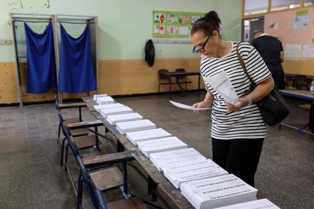 A woman prepares to cast her ballot at a polling station during parliamentary elections in Algiers on July 2, 2026. Algerians headed to the polls on July 2 to elect a new parliament in an election shadowed by expectations of low turnout among the 25-million-person electorate. (Photo by AFP)