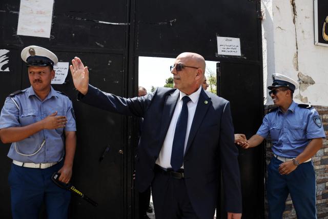 Head of Algeria's Islamist Movement of Society for Peace (MSP) Abdelaali Hassani Cherif waves at a polling station during parliamentary elections in Algiers on July 2, 2026. Algerians headed to the polls on July 2 to elect a new parliament in an election shadowed by expectations of low turnout among the 25-million-person electorate. (Photo by AFP)