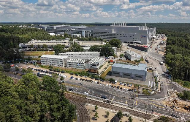 This aerial view shows the new Smart Power Fab of German semiconductor manufacturer Infineon Technologies AG in Dresden, eastern Germany, on July 2, 2026. German semiconductor giant Infineon opened a five-billion-euro ($5.7 billion) microchip plant on July 2, at a time Europe seeks to bolster its high-tech autonomy. The "Smart Power Fab" in the eastern city of Dresden, completed three months ahead of schedule, has been hailed as a symbol of an EU push to reduce dependency for crucial parts on Asia and the United States. (Photo by Ronny HARTMANN / AFP)