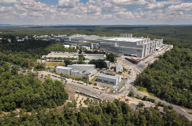 This aerial view shows the new Smart Power Fab of German semiconductor manufacturer Infineon Technologies AG in Dresden, eastern Germany, on July 2, 2026. German semiconductor giant Infineon opened a five-billion-euro ($5.7 billion) microchip plant on July 2, at a time Europe seeks to bolster its high-tech autonomy. The "Smart Power Fab" in the eastern city of Dresden, completed three months ahead of schedule, has been hailed as a symbol of an EU push to reduce dependency for crucial parts on Asia and the United States. (Photo by Ronny HARTMANN / AFP)