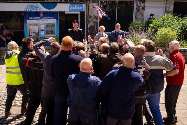 Britain's King Charles III (behind C) starts a traditional game of hand ba', during a visit to coincide with the Jethart Callant Festival in Jedburgh, Scotland on July 2, 2026. (Photo by Aaron Chown / POOL / AFP)