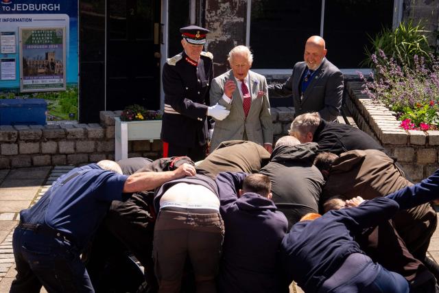 Britain's King Charles III (back C) watches a traditional game of hand ba', during a visit to coincide with the Jethart Callant Festival in Jedburgh, Scotland on July 2, 2026. (Photo by Aaron Chown / POOL / AFP)