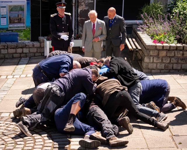 Britain's King Charles III (back C) watches a traditional game of hand ba', during a visit to coincide with the Jethart Callant Festival in Jedburgh, Scotland on July 2, 2026. (Photo by Aaron Chown / POOL / AFP)