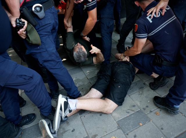 Police detain protesters as violent clashes erupted between police and demonstrators on the sidelines of a demonstration against a controversial luxury resort development linked to US President near a protected natural area, outside the parliament, in Tirana, on July 2, 2026. Since late May, protests have been held against the construction of a luxury hotel linked to Donald Trump's daughter and her husband in a nature reserve in Zvernec, on Albania's southwestern coast. For the second time this week, large groups of protesters had gathered outside the country's parliament in an attempt to confront lawmakers and block entry to the building. (Photo by Adnan Beci / AFP)