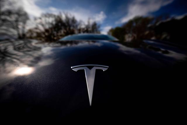 (FILES) This photograph shows a Tesla logo on a car in Lyon on April 2, 2025. Tesla reported a jump in second-quarter auto sales on July 2, 2026, as Elon Musk's electric vehicle company easily topped expectations in a period of lofty gasoline prices due to the US-Iran war. Tesla's global deliveries came in at 480,126, up 25 percent from the year-ago period when Musk's work in President Donald Trump's administration sparked consumer boycotts and protest. (Photo by Alex MARTIN / AFP)