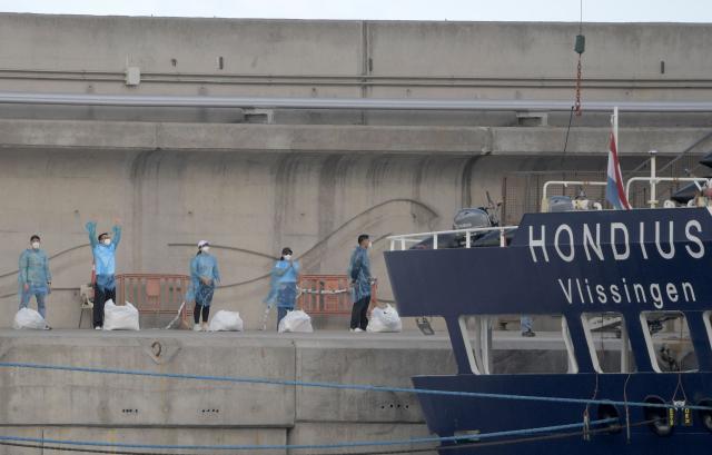 (FILES) Persons with protective suits wait in line after disembarking from the hantavirus-stricken cruise ship MV Hondius docked in the port of Granadilla de Abona on the island of Tenerife in Spain's Canary Islands on May 11, 2026. The UN health agency on July 2, 2026 declared an end to the deadly hantavirus outbreak on a cruise ship which sparked international alarm, after the last person left quarantine. World Health Organization (WHO) chief Tedros Adhanom Ghebreyesus told a press conference he was "very pleased to say that WHO considers the outbreak of hantavirus over". (Photo by JORGE GUERRERO / AFP)