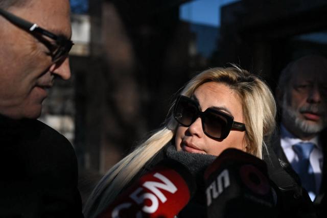 Veronica Ojeda, ex-wife of late Argentine football legend Diego Maradona speaks with the press as she arrives with Mario Baudry (L), lawyer of her son Diego Fernando Maradona, at the San Isidro court ahead of the trial for his death in San Isidro, Buenos Aires on July 2, 2026. (Photo by Luis ROBAYO / AFP)
