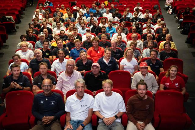 Skippers pose for a family picture during the kick-off of the 13th Route du Rhum, on June 30, 2026 at the Hermine theater in Saint-Malo, western France. From Saint-Malo in Brittany to Pointe-à-Pitre in Guadeloupe, over 100 skippers across 6 classes will take the start on November 1, 2026, in this solo transatlantic sailing race. (Photo by Julien DE ROSA / AFP)