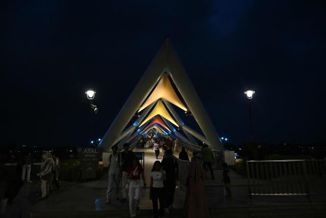 People walk at Sabarmati riverfront in Ahmedabad on July 2, 2026. (Photo by Shammi MEHRA / AFP)