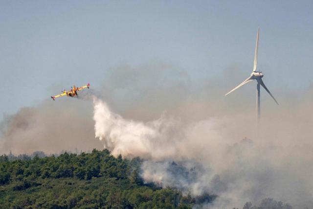 A Canadair fights against a wildfire in Pouzols-Minervois, southwestern of France,  on July 2, 2026. Hundreds of firefighters are battling wildfires in the south that are being fueled by wind, drought, and heat. The largest fire is in the Aude department, but there are also fires north of Marseille, where Prime Minister is expected to chair a new interministerial crisis task force. (Photo by Idriss Bigou-Gilles / AFP)