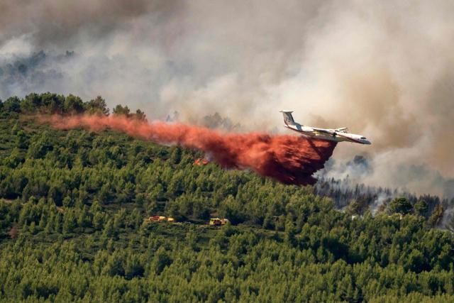 A Dash 8-Q400MR Fireguard aircraft of the civil security drops retardant over a wildfire in Pouzols-Minervois, southwestern of France,  on July 2, 2026. Hundreds of firefighters are battling wildfires in the south that are being fueled by wind, drought, and heat. The largest fire is in the Aude department, but there are also fires north of Marseille, where Prime Minister is expected to chair a new interministerial crisis task force. (Photo by Idriss Bigou-Gilles / AFP)