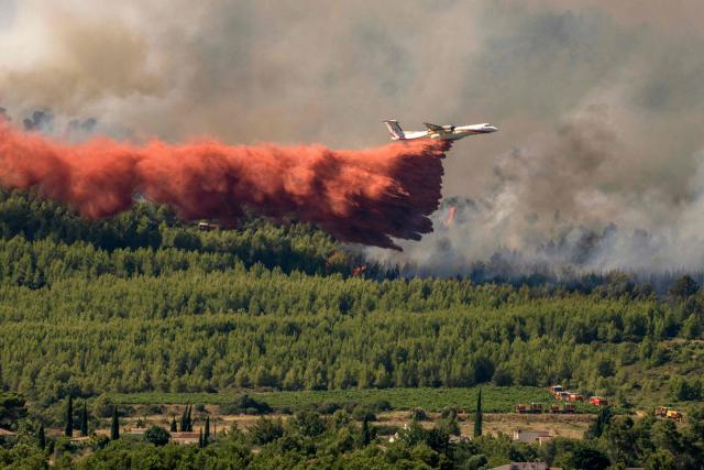 A Dash 8-Q400MR Fireguard aircraft of the civil security drops retardant over a wildfire in Pouzols-Minervois, southwestern of France,  on July 2, 2026. Hundreds of firefighters are battling wildfires in the south that are being fueled by wind, drought, and heat. The largest fire is in the Aude department, but there are also fires north of Marseille, where Prime Minister is expected to chair a new interministerial crisis task force. (Photo by Idriss Bigou-Gilles / AFP)