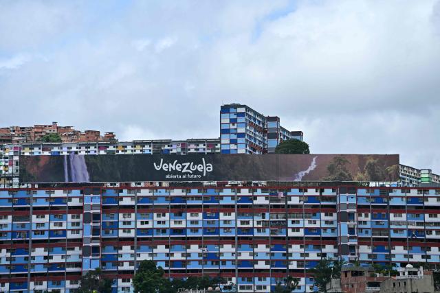 View of a building with a sign reading "Venezuela open to the future" in Caracas on July 2, 2026, eight days after twin earthquakes. Hundreds of rescuers in Venezuela cheered and embraced on July 2, 2026 after pulling 43-year-old Hernan Gil from the ruins of a collapsed building eight days after deadly twin earthquakes, AFP journalists witnessed. (Photo by MARTIN BERNETTI / AFP)