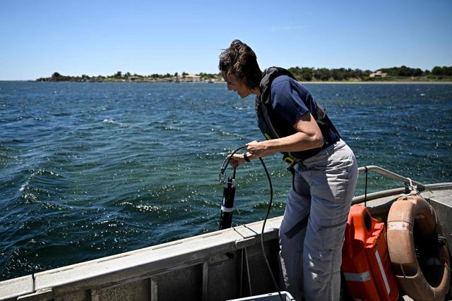 A scientific researcher analyses the temperature and oxygen levels of the waters of the Etang de Thau, off Sète, southern France, during a media day organised by French Research Institute for Exploitation of the Sea (Ifremer) near Sete, southern France, on July 2, 2026. The world's oceans just experienced their hottest June on record and could set fresh highs in the months ahead as El Nino and climate change drive temperatures even higher, scientists said on July 1. (Photo by Gabriel BOUYS / AFP)