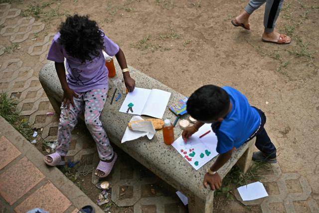 Displaced children play at a camp at the Ali West Park in Caracas on July 2, 2026, eight days after twin earthquakes. Hundreds of rescuers in Venezuela cheered and embraced on July 2, 2026 after pulling 43-year-old Hernan Gil from the ruins of a collapsed building eight days after deadly twin earthquakes, AFP journalists witnessed. (Photo by MARTIN BERNETTI / AFP)