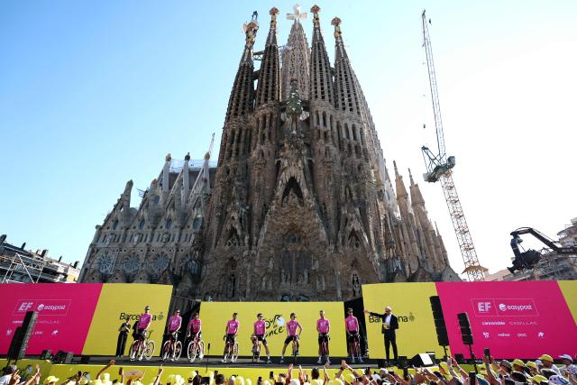 EF Education - Easypost team riders attend the team presentation ceremony ahead of the 113th edition of the Tour de France cycling race, with the Sagrada Familia Basilica seen in the background, in Barcelona, northeastern Spain, on July 2, 2026. (Photo by Anne-Christine POUJOULAT / AFP)