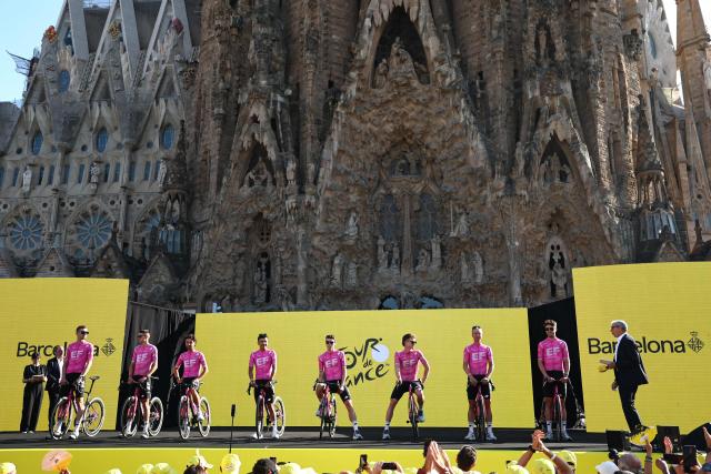 EF Education - Easypost team riders attend the team presentation ceremony ahead of the 113th edition of the Tour de France cycling race, with the Sagrada Familia Basilica seen in the background, in Barcelona, northeastern Spain, on July 2, 2026. (Photo by Anne-Christine POUJOULAT / AFP)