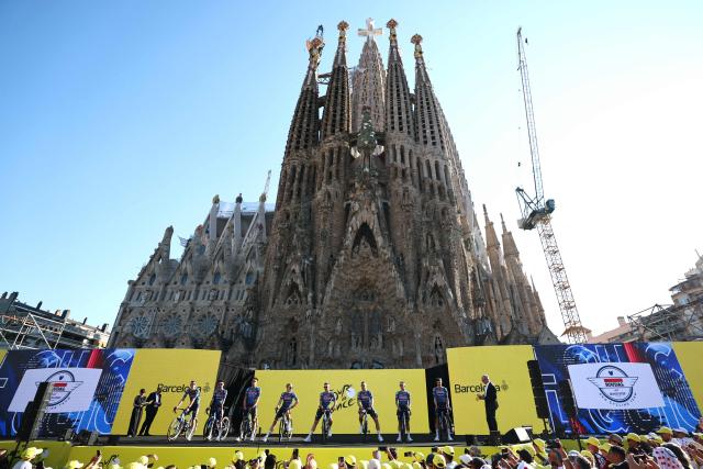 Soudal Quick-Step riders attend the team presentation ceremony ahead of the 113th edition of the Tour de France cycling race, with the Sagrada Familia Basilica  seen in the background, in Barcelona, northeastern Spain, on July 2, 2026. (Photo by Anne-Christine POUJOULAT / AFP)