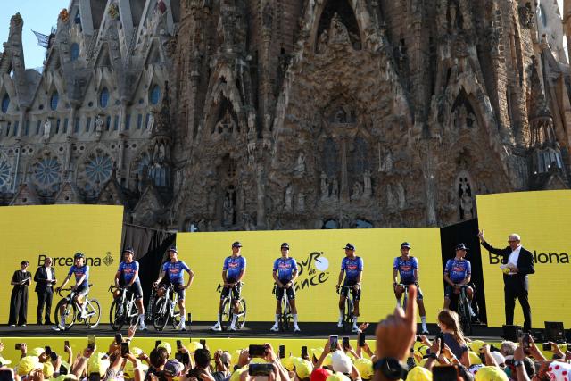 Alpecin - Premier Tech team's riders attends the team presentation ceremony ahead of the 113th edition of the Tour de France cycling race, with the Sagrada Familia Basilica  seen in the background, in Barcelona, northeastern Spain, on July 2, 2026. (Photo by Anne-Christine POUJOULAT / AFP)