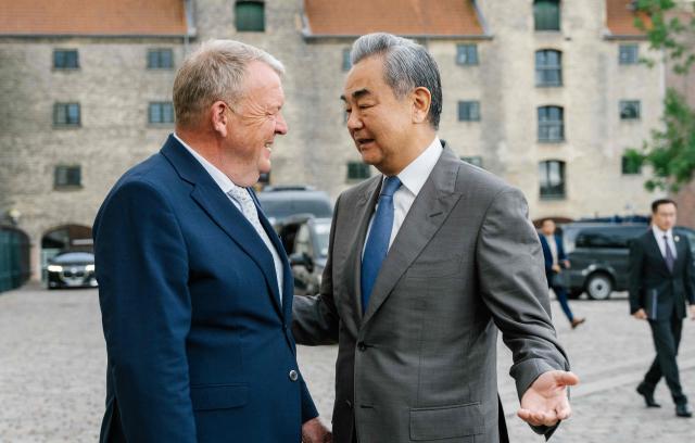 Danish Foreign Minister Lars Loekke Rasmussen (L) welcomes China's Foreign Minister Wang Yi at the Ministry of Foreign Affairs in Copenhagen on July 2, 2026. The Chinese Foreign Minister visits Denmark on July 2 and 3, 2026. He will furthermore visit Sweden, Finland, and Norway. (Photo by Emil Nicolai Helms / Ritzau Scanpix / AFP) / Denmark OUT